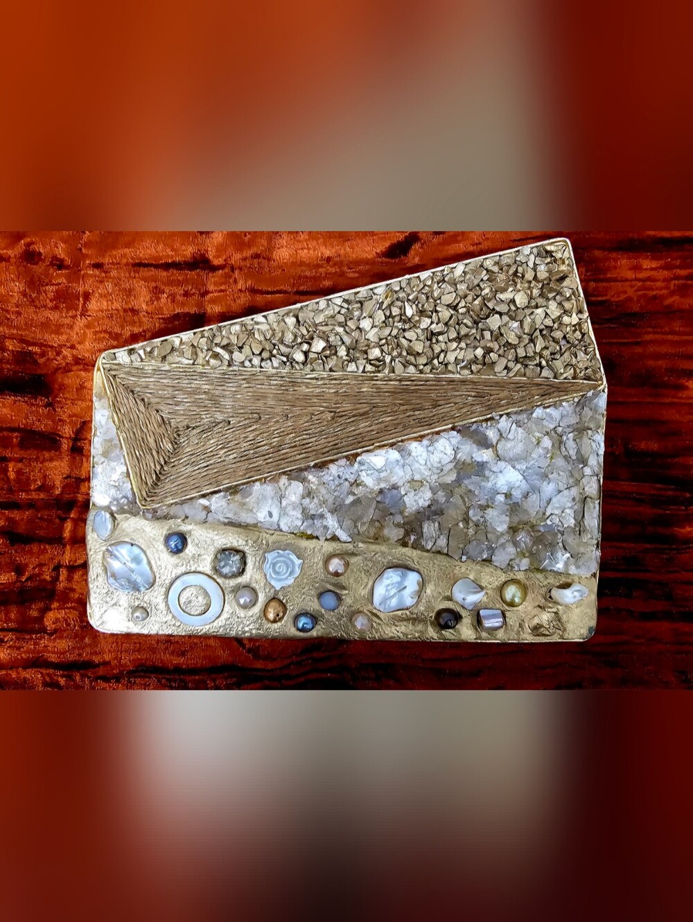 This is a rigid, box-style clutch bag with a rectangular base